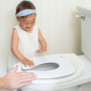 Happy Toddler Being Shown Deployed Potty Proud Seat on Toilet